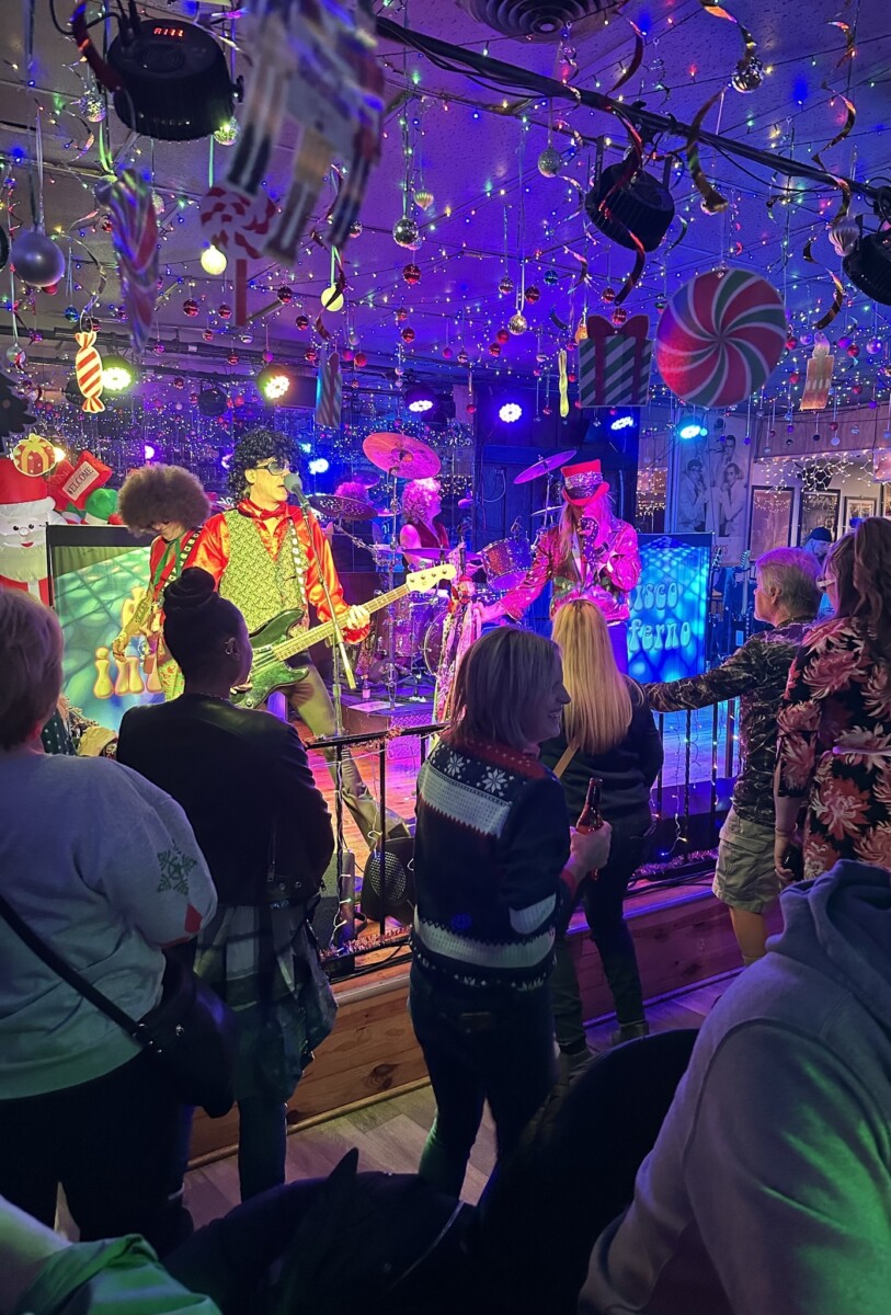 Band performing in club decorated for Christmas